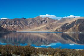 Pangong Tso lake blue water with mountains reflection in Ladakh